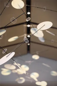 A modern installation art sculpture made of metal steel, hanging from the ceiling.