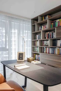 Modern office library featuring a wooden bookshelf with numerous books.