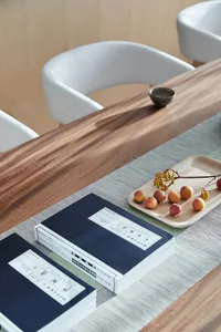A minimalist table with books and fruits on a wooden surface