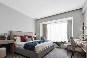 A modern bedroom featuring contemporary furniture and minimalist decor.