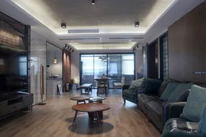 A modern industrial living room with exposed brick walls and wooden furniture.