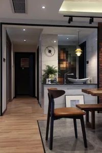 A modern dining room featuring wooden furniture and a sleek black marble countertop.