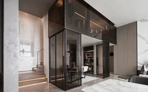 A modern home office featuring glass walls, marble finishes, and a staircase.