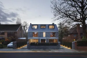 Modern house with brick exterior and large windows.