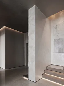 Modern interior design with concrete staircase featuring built-in lighting.