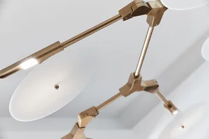 Close-up of modern lighting fixture with metallic and glass elements.