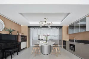 A modern kitchen with marble countertops and stools.