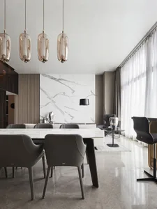 A modern living room featuring marble walls and furniture.