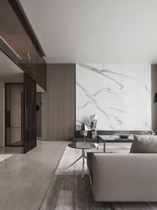 Modern living room featuring marble walls and glass furniture.