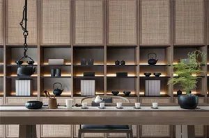 A modern living room featuring wooden furniture and rattan accents, with a tea service on the table.