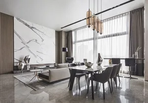A modern living and dining space featuring marble and glass materials, with a large marble wall and a glass dining table.