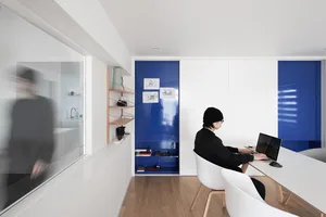 A minimalist office space featuring mixed materials