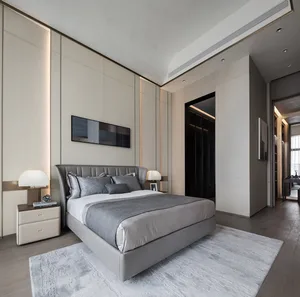 Modern minimalist bedroom featuring a grey leather bed with matching quilt and pillows, wooden flooring, and a modern rug. Wa