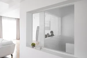 A minimalist interior with a large window made of glass.