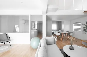 A modern minimalist living room featuring wooden furniture and decor.