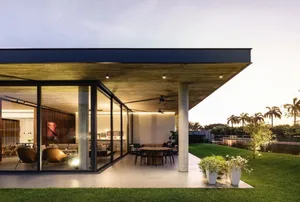 Modern residential design featuring concrete, glass, and wood materials.