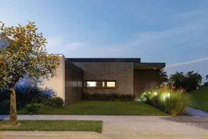 Modern residential exterior featuring concrete and corrugated metal materials