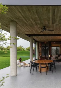 A modern residential exterior featuring concrete and glass materials.