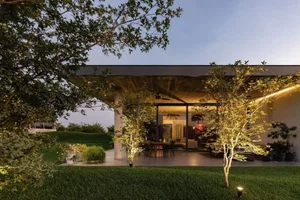 A modern residential exterior with concrete and wood materials.