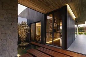 Modern architectural design featuring metal cladding interior with large glass windows.