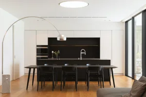 Modern minimalist kitchen with black and white color scheme and sleek, contemporary fixtures.