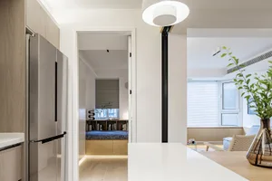 A modern kitchen with white concrete countertops, wooden cabinets, and a white dining area.