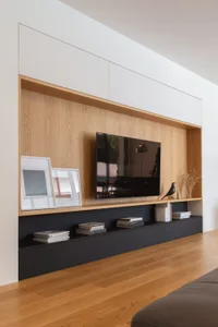 Modern minimalist living room featuring a wooden floor, glass shelving, and contemporary furniture.