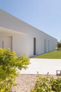 Modern residential home featuring white stucco exterior with minimalist design.