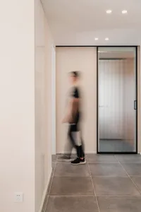 A frosted glass door is installed within a modern, minimalist home decor setting.
