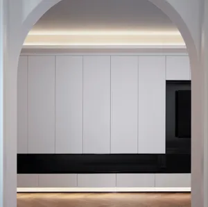 A minimalist white living room featuring modern white cabinets with a black base.