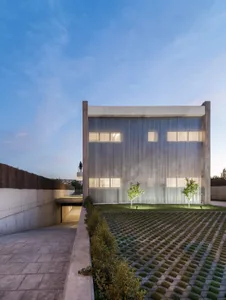 Modern building with metal siding and concrete elements on exterior.