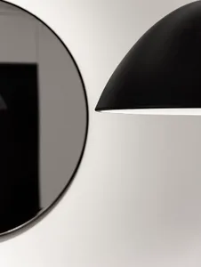 A modern light fixture with a black aluminum shade