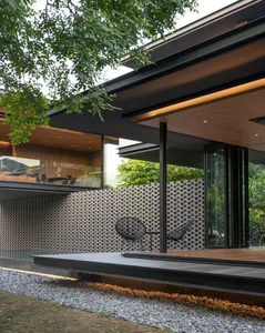 A modern outdoor space featuring a metal structure and seating area.
