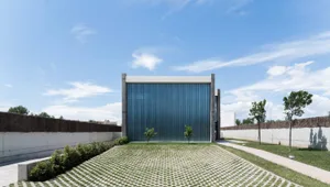 Modern building with a metal facade and concrete elements.