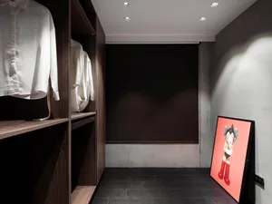 A modern closet with dark wooden shelving and a single drawing of a character on the wall.