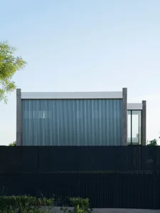 A modern, minimalist residential exterior with metal cladding.