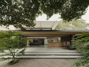 A modern residential kitchen with concrete and wooden surfaces.
