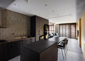 A modern kitchen featuring industrial concrete and dark wood accents.