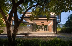 Urban house exterior featuring modern architectural design, with a mix of wooden and glass panels and a contemporary style.