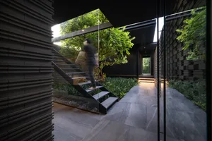 A modern residential staircase with metal and glass design elements