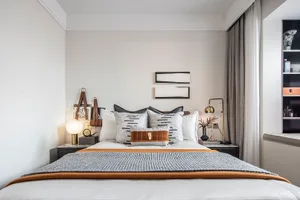 Modern minimalist bedroom with a bed, nightstands, and decorative elements.