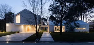 Modern house with concrete exterior and large windows.