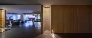 A modern living room featuring a large wooden panel wall and a purple television screen.