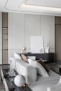 Contemporary living room featuring a modern minimalist design with a white leather couch, accentuated with soft pink pillows 