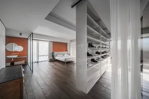 Well-lit, minimalist residential interior designed with wood, glass, and metal.