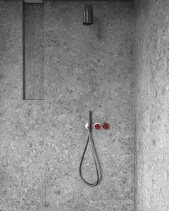 Concrete shower with minimalist design and concealed plumbing.