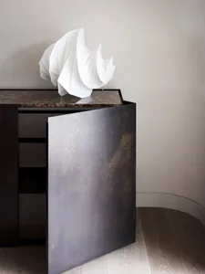 A modern cabinet made of metal, wood, and marble.