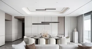 A modern dining room with a white concrete floor, white and grey walls, white pendant lights, and a long dining table.