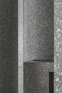 Modern interior design featuring concrete terrazzo flooring and walls.