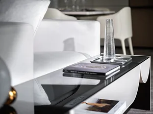 A sleek modern interior design featuring a glass side table with a minimalist aesthetic, showcasing a contemporary side table
